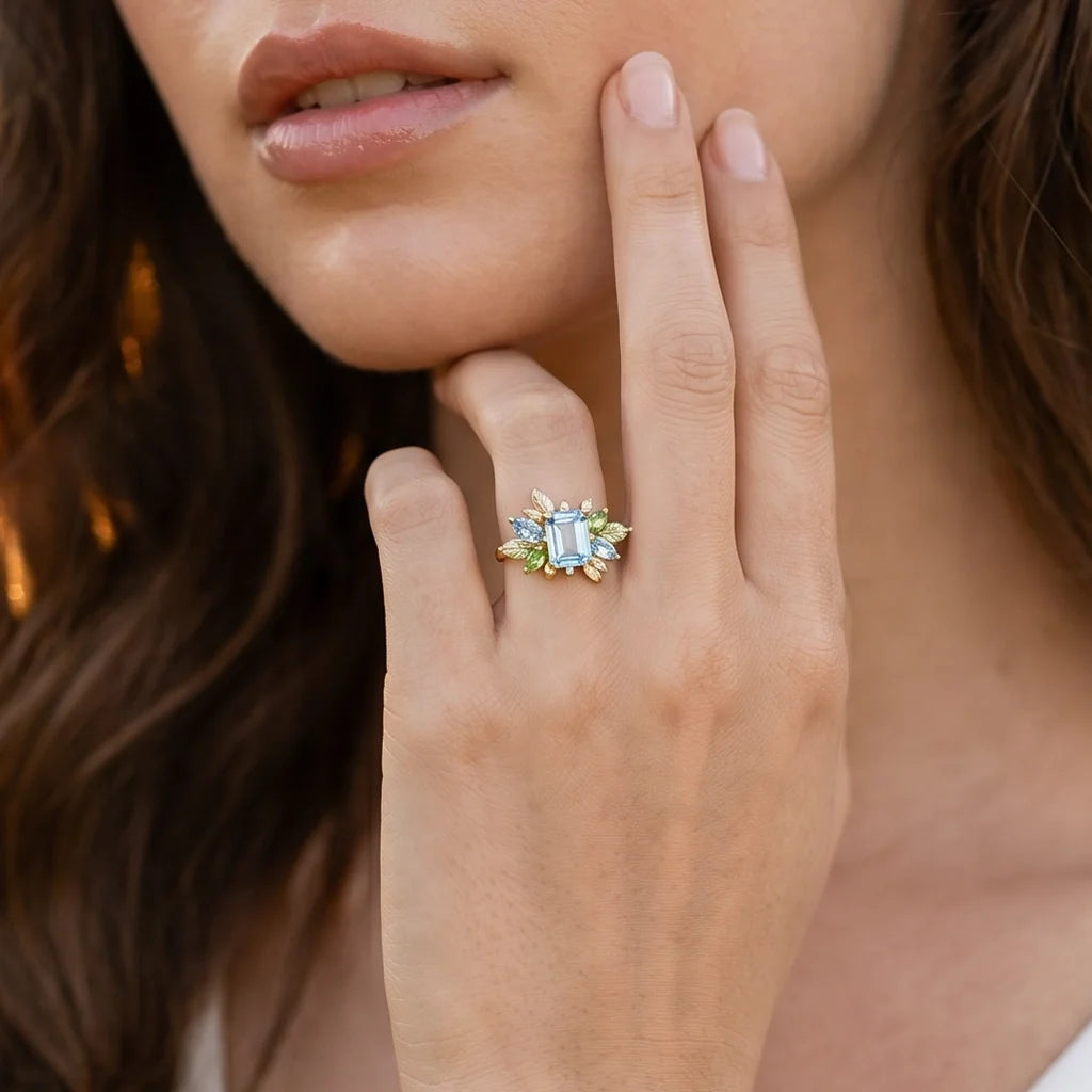 Flora’s Spring | Emerald Cut Blue Aquamarine Leaf Halo Engagement Ring
