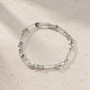White gold plated silver Axiom chain bracelet on pale stone