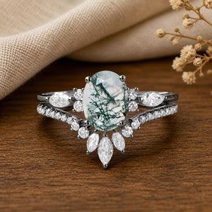 Elara's Ellipse Oval Cut Moss Agate Engagement Ring Set on walnut tabletop