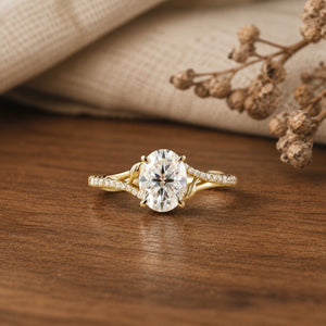 Moissanite twisted leaf engagement ring on a warm walnut tabletop