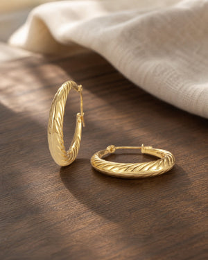 Minimalist Twist Rope Gold Hoop Earrings on warm walnut surface