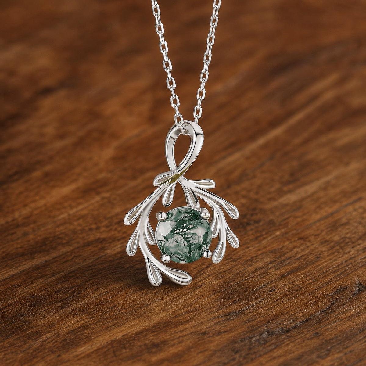 Round Natural Moss Agate Olive Branch Silver Charm Necklace on warm walnut
