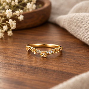 Leaf clover curved wedding band on warm walnut tabletop