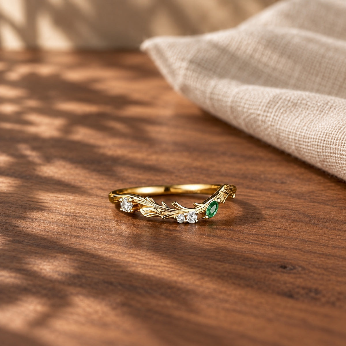 Bark Inspired curved moss agate wedding band on warm walnut tabletop