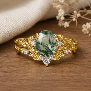 Unique heart-leaf moss agate engagement ring set on a natural walnut tabletop