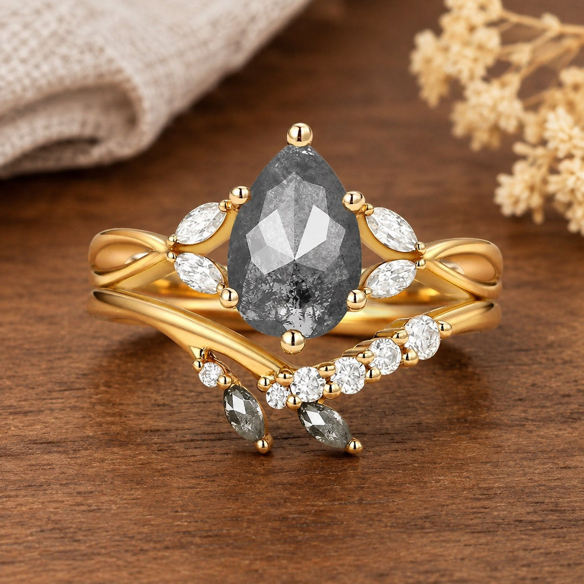 Isadora’s Reverie 1ct marquise salt-and-pepper moissanite vintage bridal set on a natural walnut tabletop