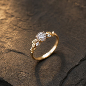 Floral vine salt and pepper diamond engagement ring on warm charcoal limestone