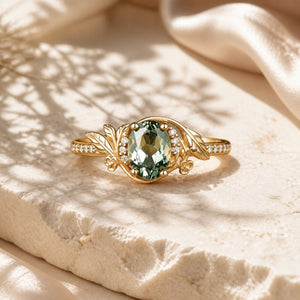 Leaf Inspired Olive Green Sapphire Flower Ring — front view on warm ivory limestone