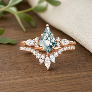 Adela's Promise Kite Cut Moss Agate Three-Stone Engagement Ring Set on natural walnut tabletop