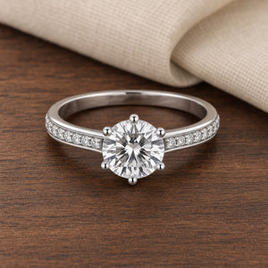 Sterling Silver Brilliant Cut Moissanite Solitaire Ring — walnut supported front view