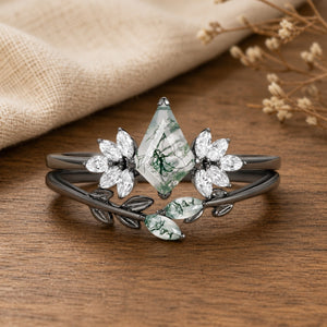 Amayah's Enclave Black Gold Moss Agate Leafy Engagement Ring Set on walnut tabletop