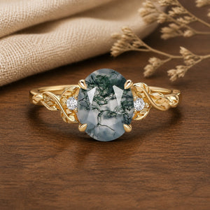 Clover Oval Cut Moss Agate Leafy Wedding Engagement Ring on walnut tabletop