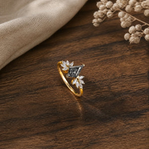 Unique kite-shaped black rutilated quartz engagement ring on a warm walnut tabletop