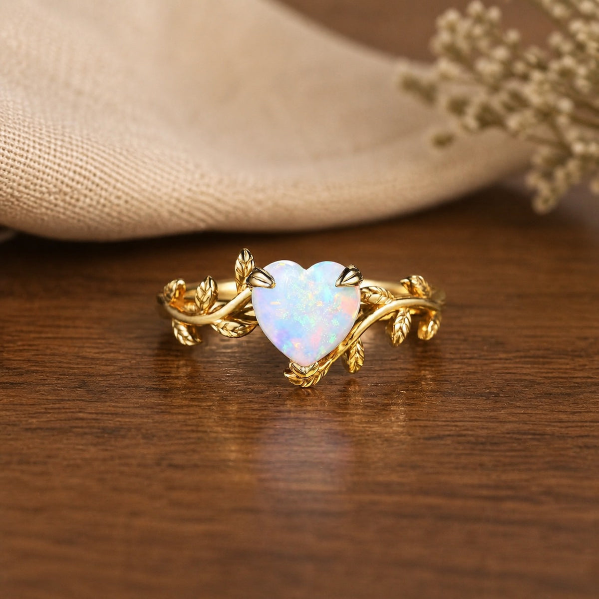 Nature Inspired heart-shaped opal ring on a warm walnut tabletop