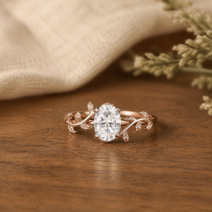 1.5ct Oval Cut Moissanite Leaf Design Engagement Ring on flat walnut tabletop