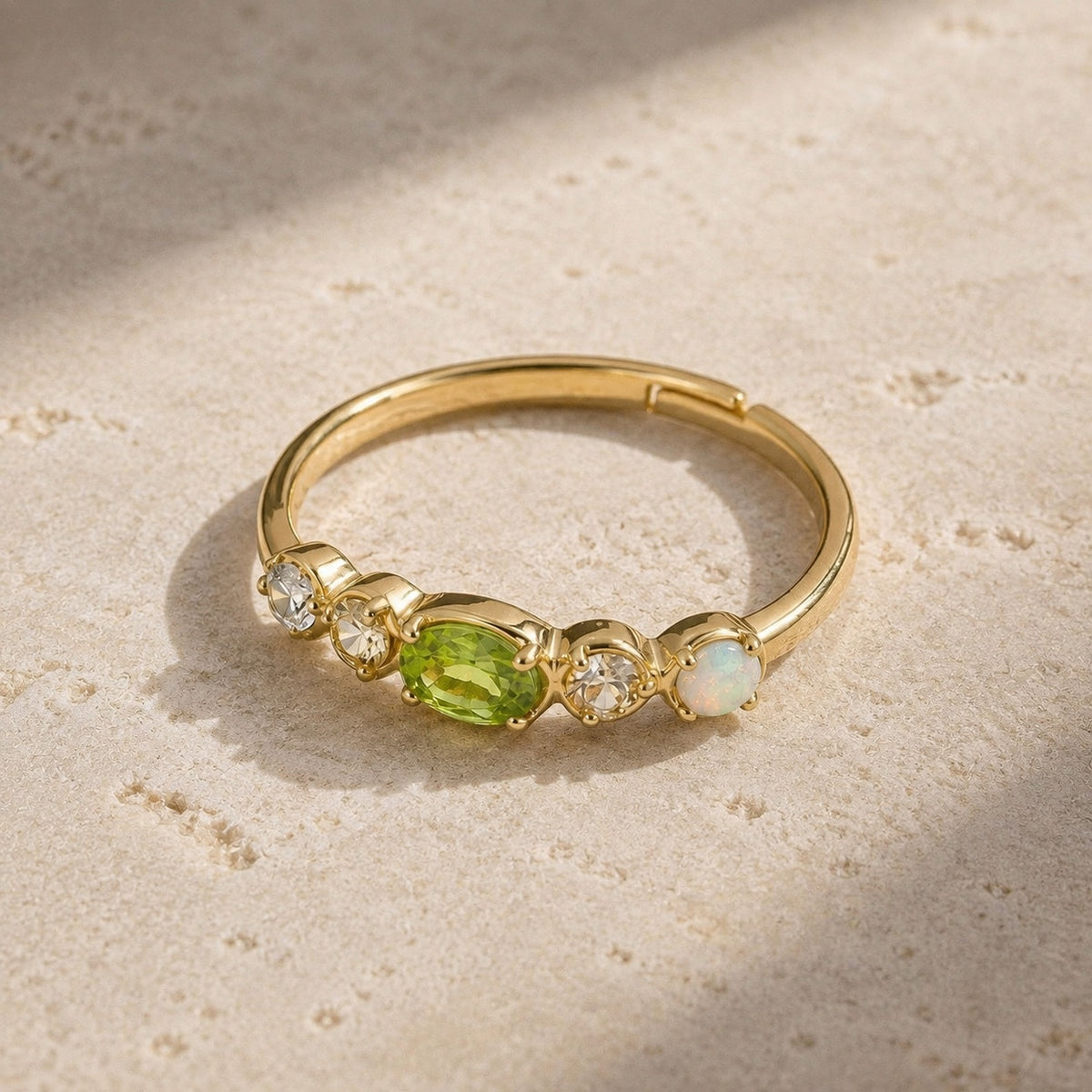 Adjustable gold peridot stacking ring with clear stones and opal accent on pale stone