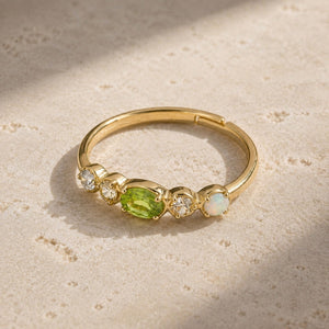 Adjustable gold peridot stacking ring with clear stones and opal accent on pale stone